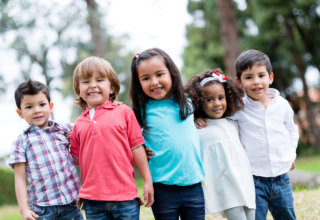 Happy group of kids smiling at the park